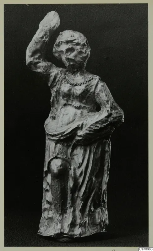 Standing figure with one arm raised, photographed against a dark background
