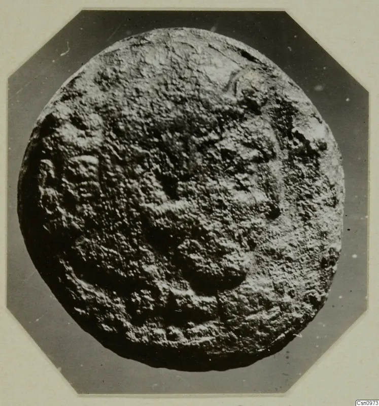 Round find from Kountoura Trachonia with a rough, encrusted surface and raised markings