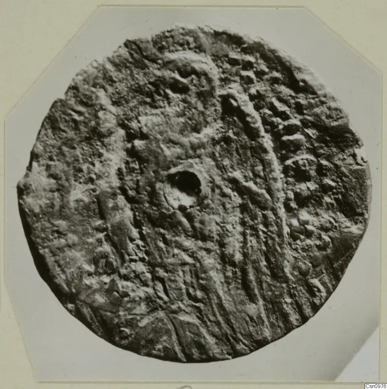 Round find from Kountoura Trachonia with a ridged, pitted surface and a central hole