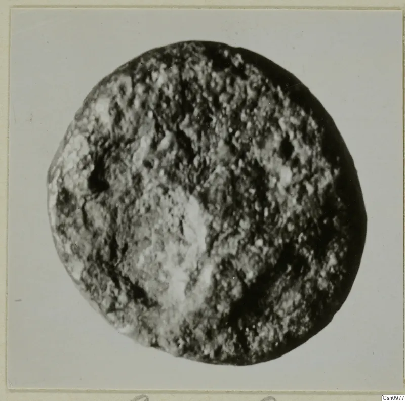 Find from Kountoura Trachonia: a round object with a pitted, granular surface, photographed close up