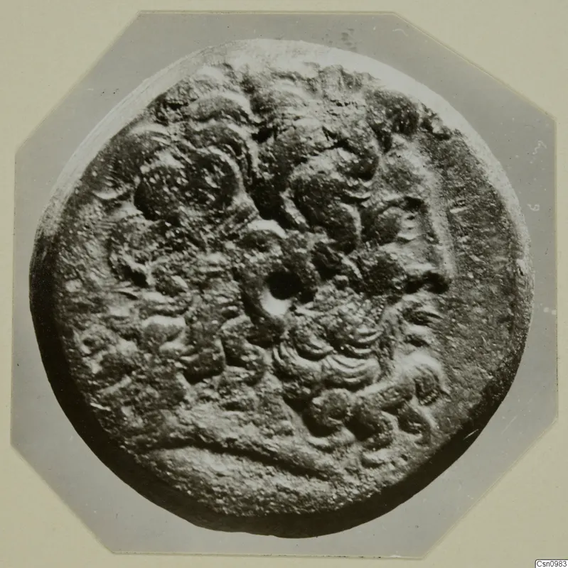 Round find with raised relief decoration, from Kountoura Trachonia.