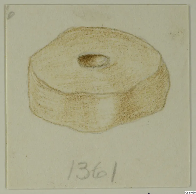 Drawing of a small disc-shaped object with a central hole, in brown crayon on card.
