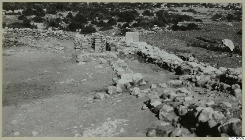 Low stone walls and foundations at Nitovikla on the Karpas Peninsula, with scrub behind
