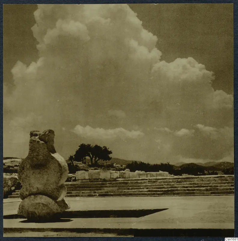 Stone steps, a rough stone object and a tree at Vouni palace under tall clouds