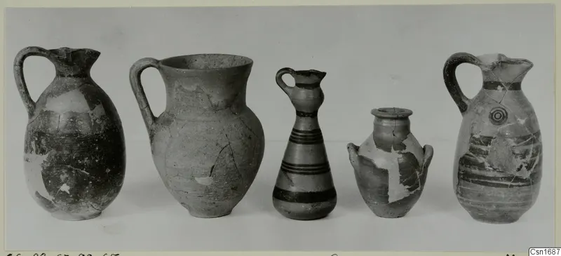 Five pottery vessels in a row, jugs and juglets with painted bands, from Marion