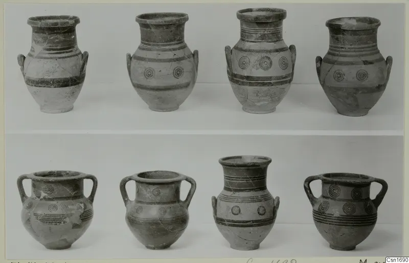 Eight painted pots from Marion arranged in two rows, four tall-necked vessels above and four two-handled jars below.