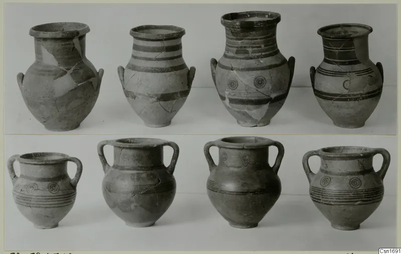 Two rows of painted pottery vessels from Marion, decorated with dark bands and concentric circles