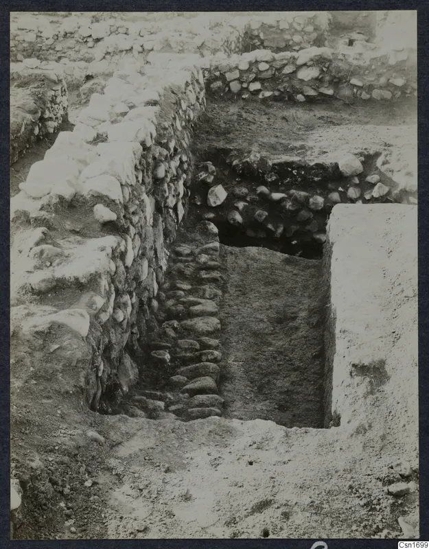 Excavated stone walls and a cobbled passage at the Cholades Temples A-B at Soli.