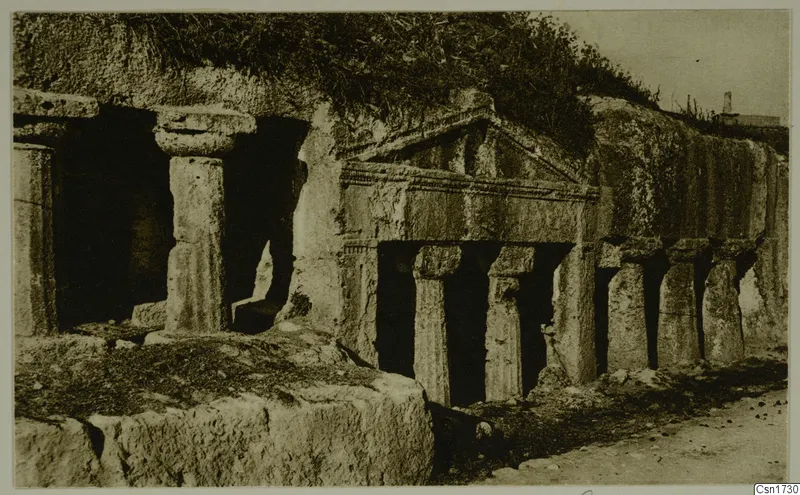 Rock-cut tomb facade with a pediment and columns cut into a hillside, North Africa