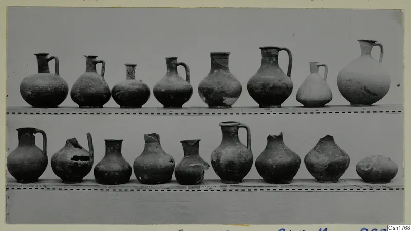 Two rows of pottery jugs and jars on shelves, from Ajii Omologitades, Politiko and Limassol Oasis