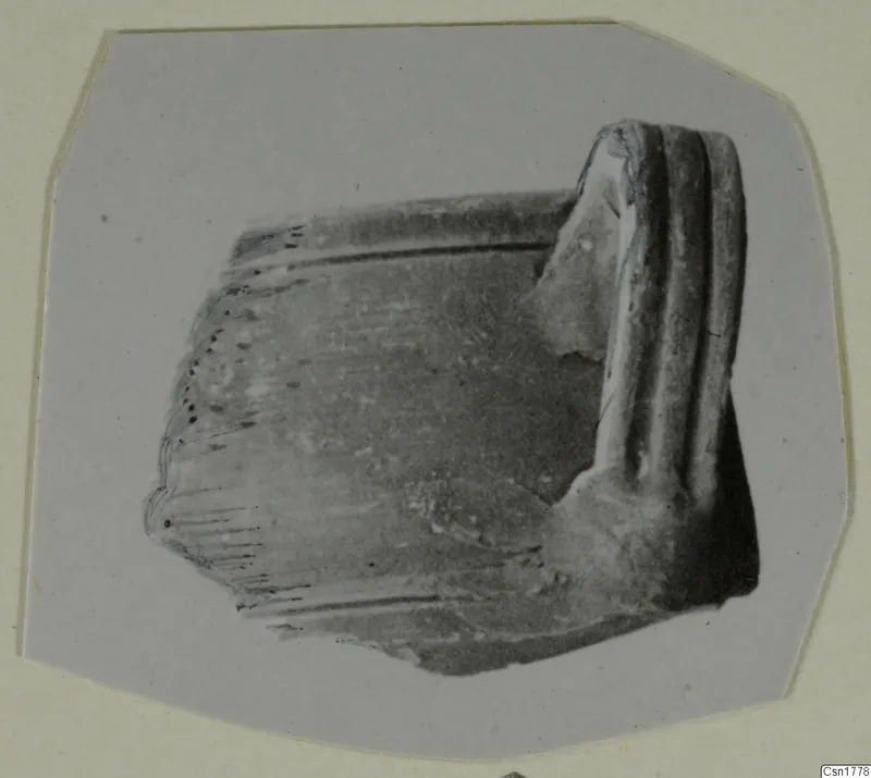 Part of a handle: a broken fragment with three raised ridges along one end