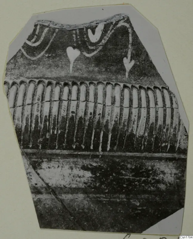 Pottery sherd with white painted swags and drop-shaped motifs above a band of vertical ribbing