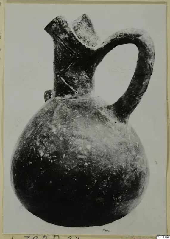 Pottery Red Polished III jug with a two-lipped spout and loop handle