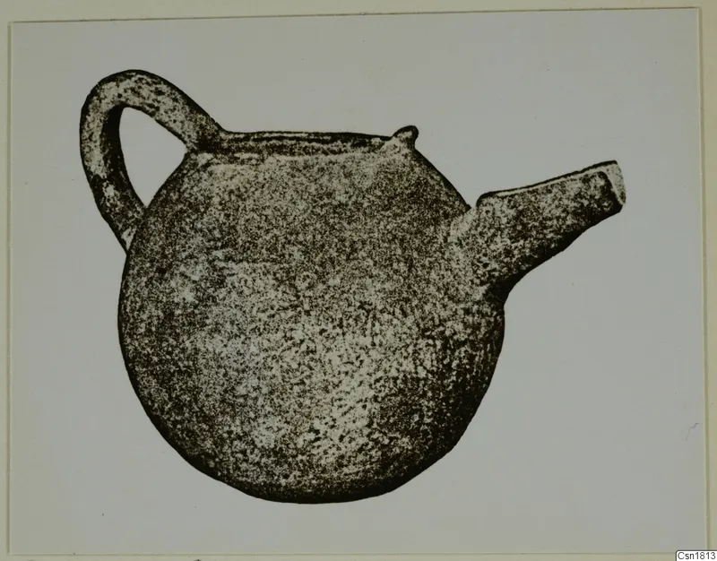 Red Polished III jug with a strap handle at the back and a short spout at the side, against a pale background.
