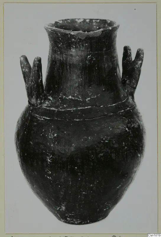 Red Polished I jar with a flaring neck, two pairs of lug handles and two raised bands around the shoulder.