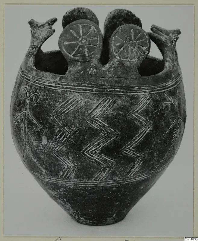 Pottery vessel Red Polished I with two beaked handles, two spoked discs on top and zigzag bands on the body