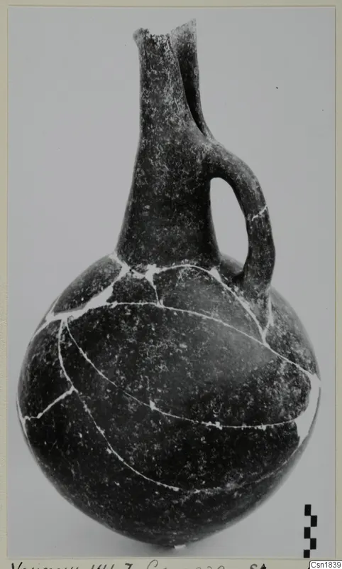 Red Polished I Stewart vessel from Vounous with a long neck and a single loop handle, mended from pieces