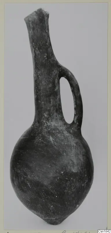 Red Polished I vessel from Vounous: a dark jug with a long neck and a single loop handle