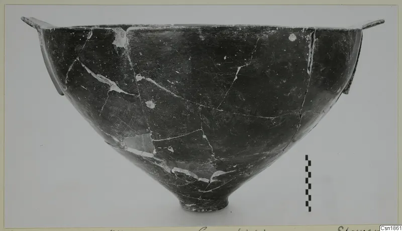 Dark polished bowl with two small horizontal handles at the rim, from Vounous
