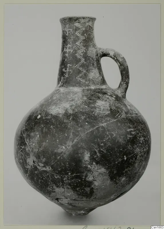 Red Polished I pottery jug with a single loop handle and pale zigzag and hatched decoration on the neck