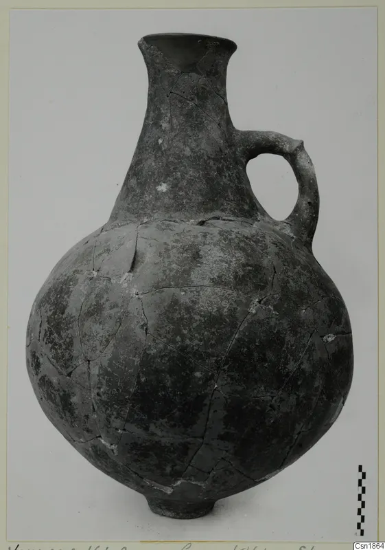 Red Polished I jug from Vounous with a loop handle, shown beside a scale bar