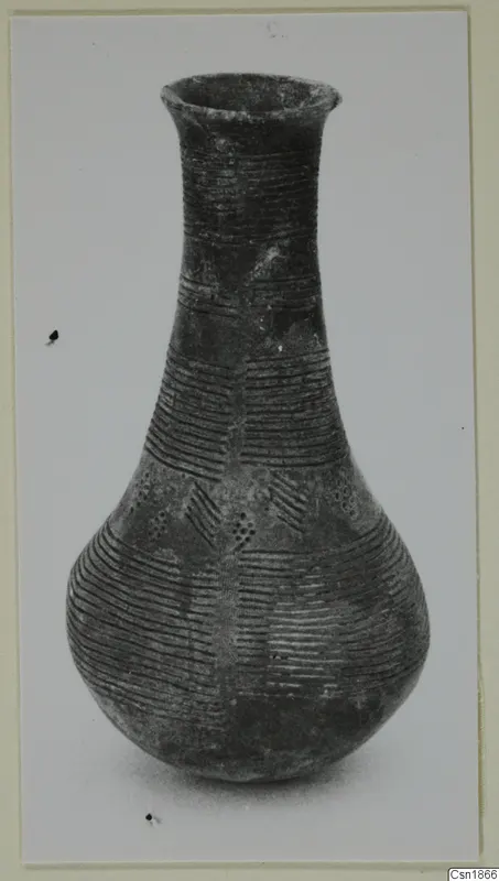 Pottery Red Polished I vessel from Vounous with a tall narrow neck and incised horizontal lines