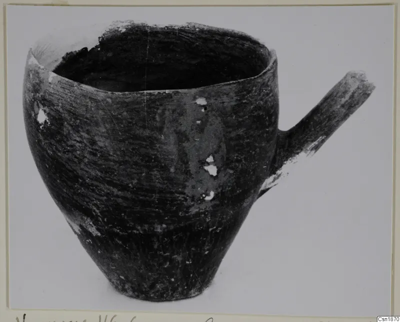 Pottery Red Polished I vessel from Vounous with a short side handle, photographed on a plain background