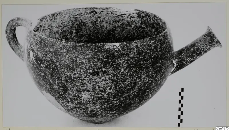 Red Polished I pottery vessel with a loop handle on the left and a flaring tubular spout on the right