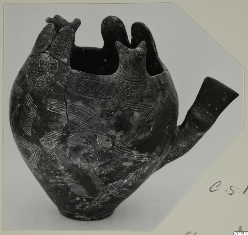 Red Polished I pottery vessel from Vounous with a tubular spout, a modelled head and incised zigzag and chevron patterns