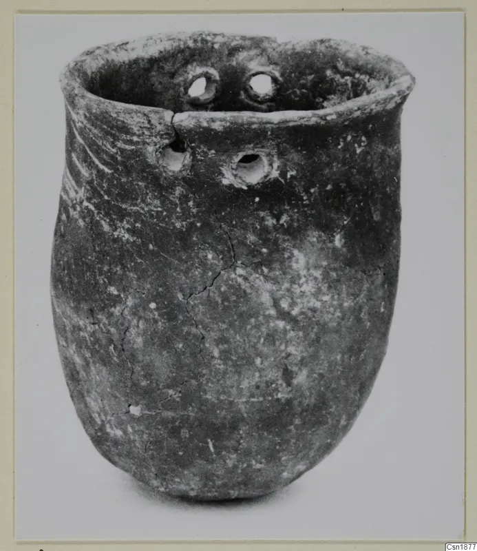 Red Polished I vessel from Vounous 153.3, with a flared rim and small holes near the top