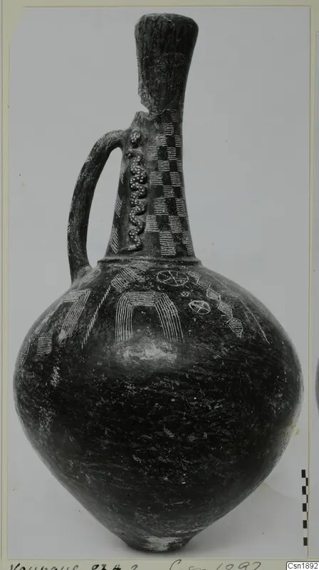 Jug from Vounous with a tall neck, strap handle and incised and applied decoration