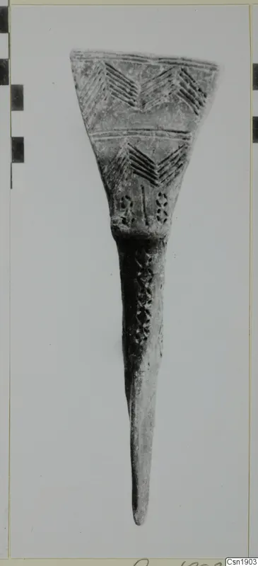 Pottery object with a wide flared top incised with chevron patterns and a long tapering stem