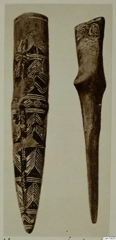 Two elongated objects side by side: the left with incised chevron bands, the right with spiral motifs on its flat top