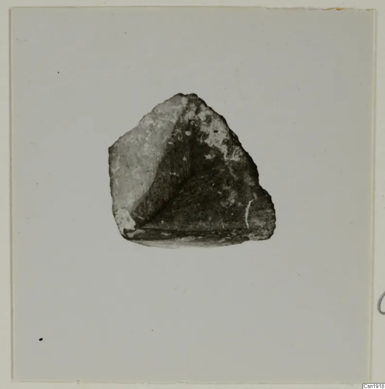 Fragment of a chisel of uralite porphyrite from Kythrea, shown on a pale mount