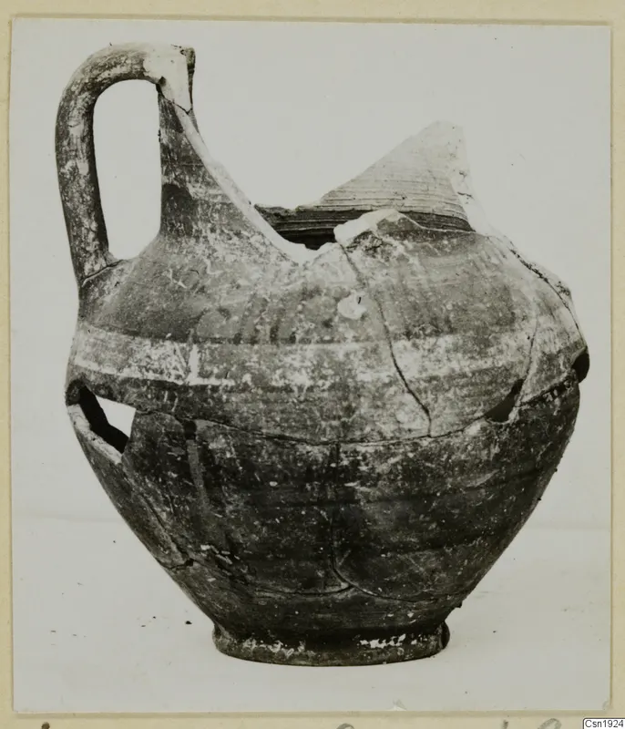Pottery jug with a tall strap handle and pale painted bands, Bichrome-Red I_IV - IV_VII, shown from the side