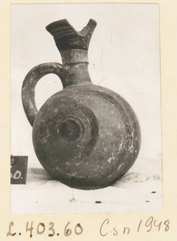 Jug from Lapithos with a flared spout, loop handle and concentric grooves on the rounded body