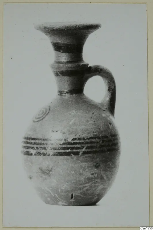 Jug in Pottery Black-on-Red I-III from the Kastros tombs at Lapithos, with black painted bands and a flared neck