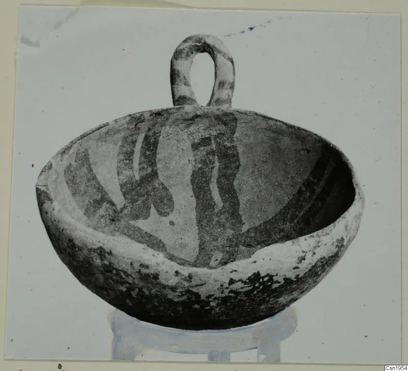 Pottery bowl with a loop handle and dark painted bands, from Ayios Iakovos