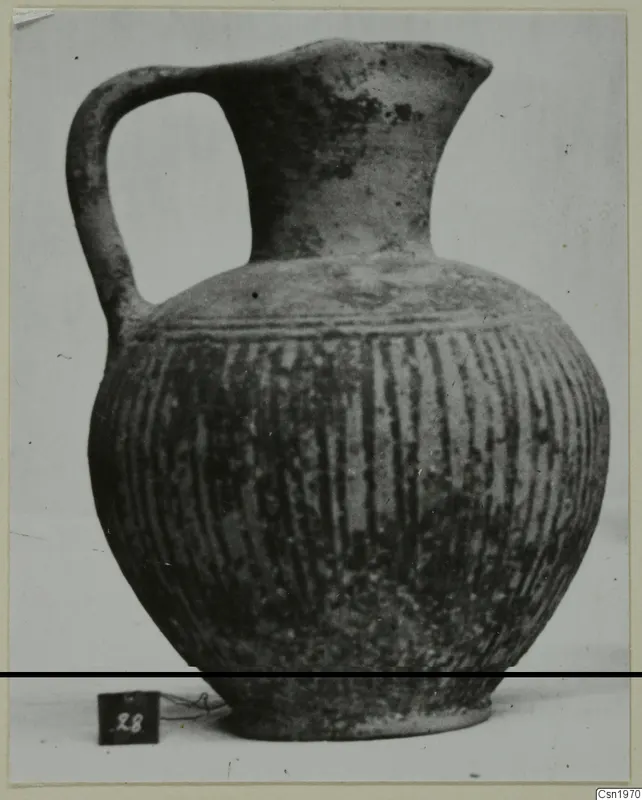 Black Slip jug with one handle and vertical grooves on the body, from the Kastros tombs at Lapithos