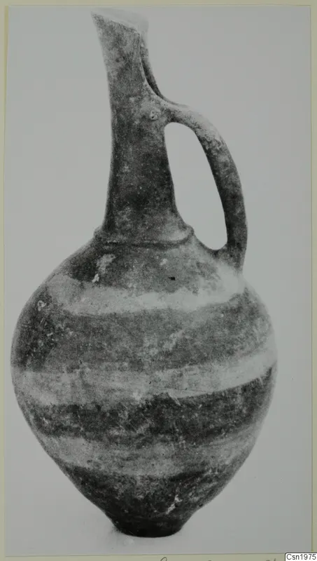 Pottery Reserved Ware jug with a long neck, single handle and banded body, from Vounous