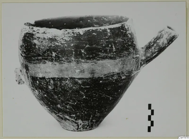 Reserved Ware pottery vessel from Vounous with a tubular spout and a pale band around its body.