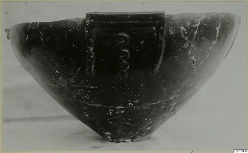 Pottery Red Polished III bowl with a raised panel bearing a coiled relief on its side