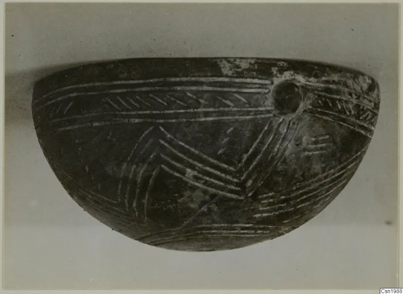 Red Polished III Bowl, a dark bowl with incised chevron and line decoration and a round lug on the upper right.