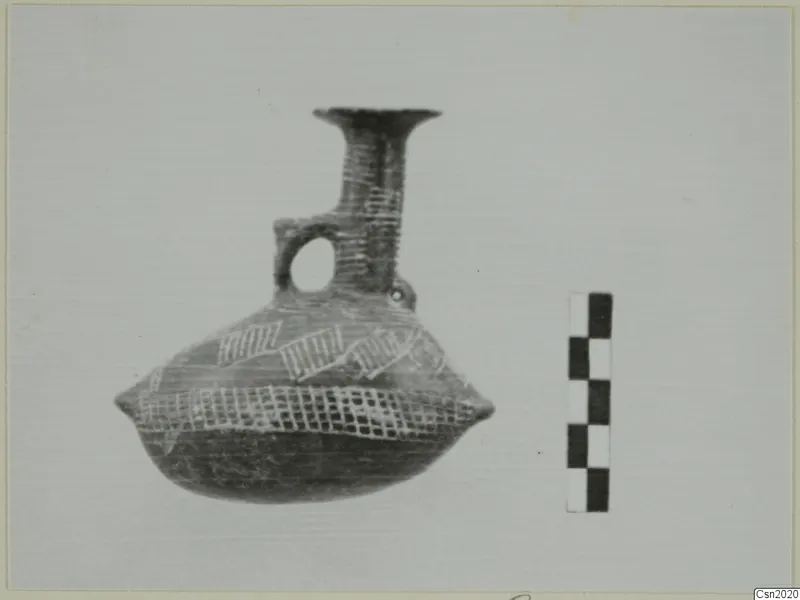 Pottery vessel with a flaring neck and loop handle, painted with lattice and hatched bands, beside a scale bar