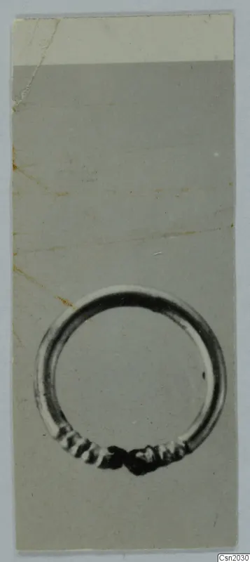 Ring from Marion: a closed metal ring with a ribbed, coiled section at the bottom where its ends meet
