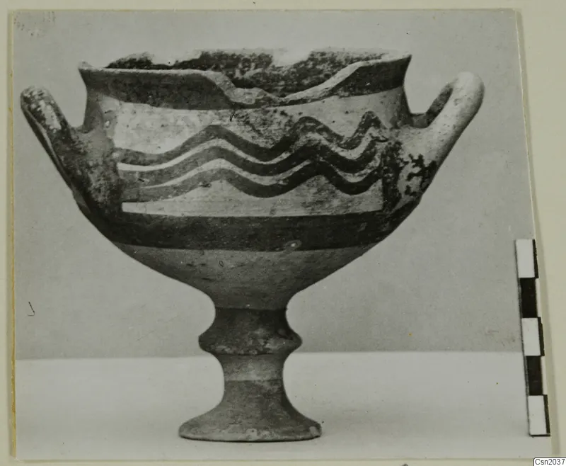 White Painted I bowl on a low stem foot, with two handles and wavy painted bands around the body