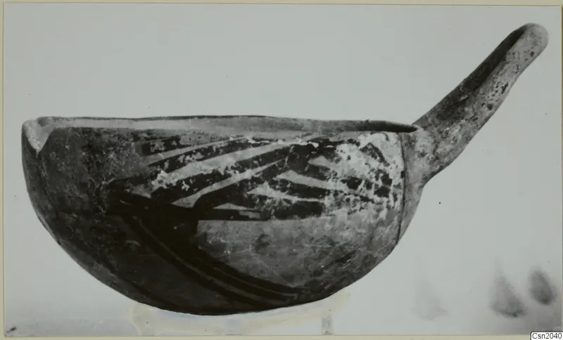 Pottery White Painted I - II: a bowl with one long handle and dark painted bands, seen from the side