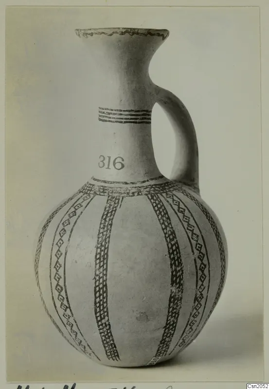 Jug with a single strap handle, white slip and dark painted bands and lattice panels, with the number 316 on the neck.