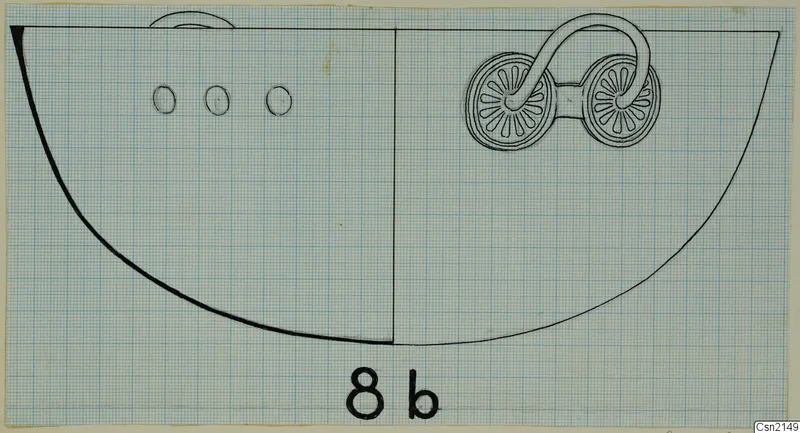 Drawing of a bowl on graph paper, showing a curved loop handle with two disc-shaped rosettes and small oval marks on the body