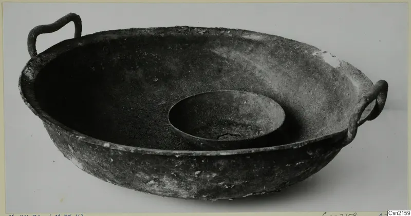 Two bowls: a large shallow bowl with two loop handles, with a smaller bowl set inside it